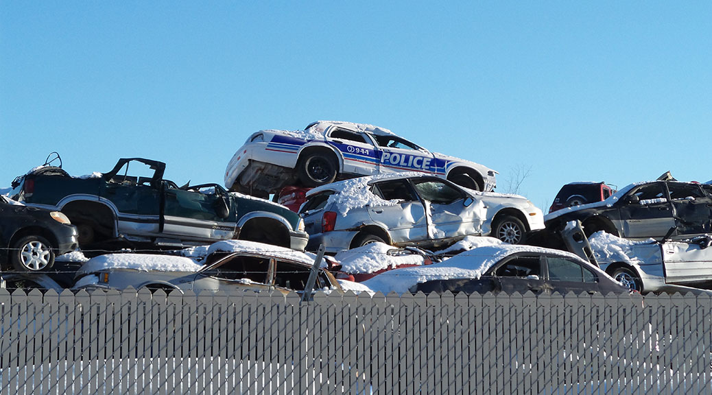 Cherry on top: Police car on top of a trash heap at the Cash for Trash junkyard on Flewellyn Road.