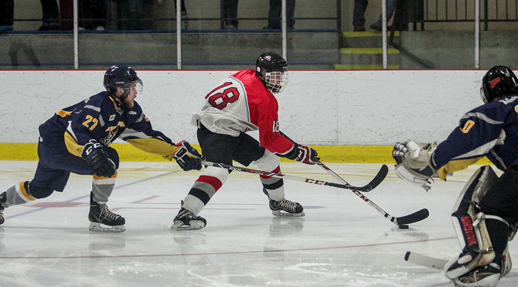 Rams player Cole Carter slips past Renfrew's Blair Barr. The Rams won game four 6-3 and the series over the Renfrew Timberwolves in four straight games clinching the Eastern Ontario Junior Hockey League Valley Division. Photo by Barry Gray.