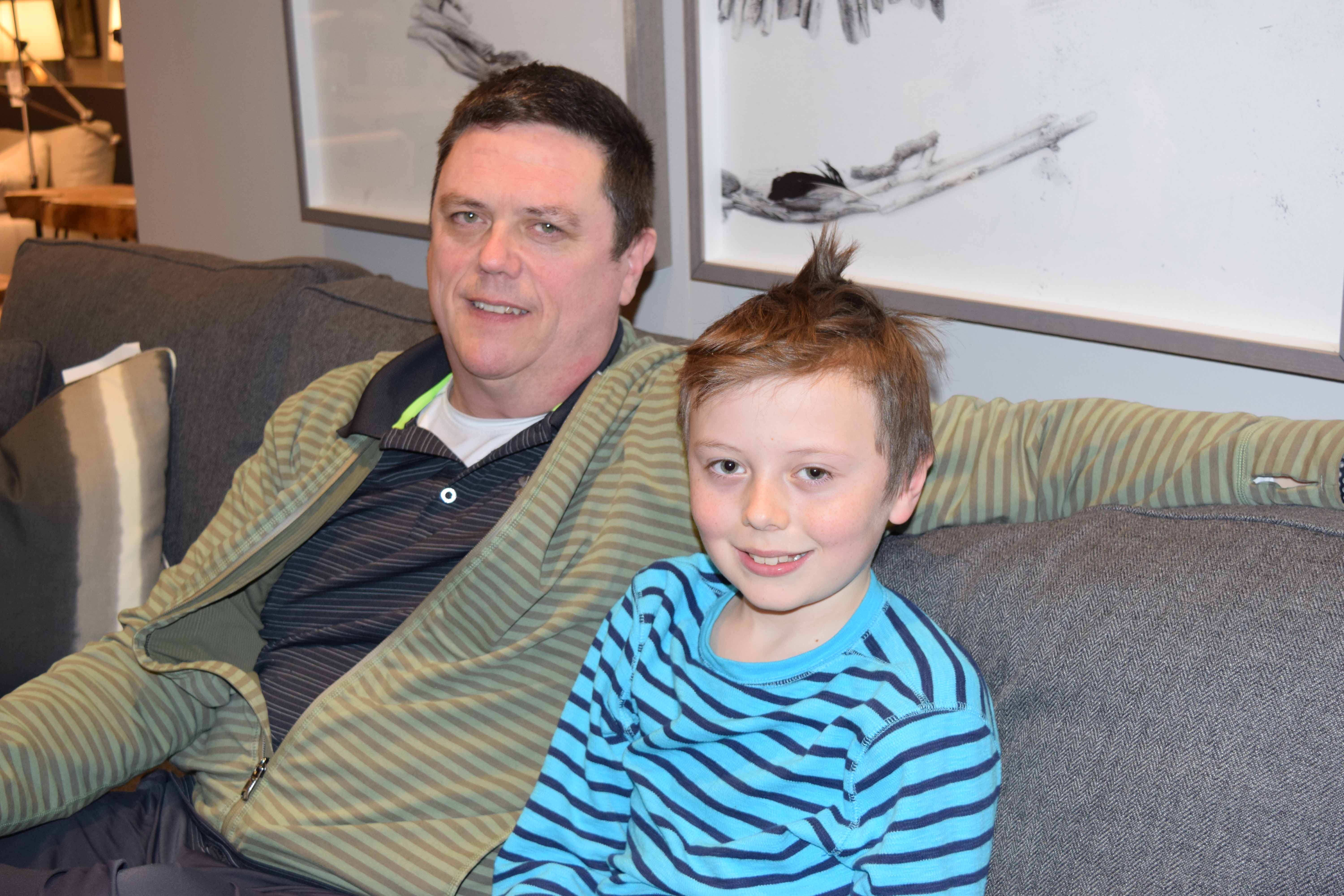 Sean O’Leary with his son, Ronan, inside the family store MYHome Furniture in Kanata. O’Leary says he is trying to give his children as normal a life as possible as his daughter struggles with drug addiction. (Devyn Barrie/OttawaStart.com)