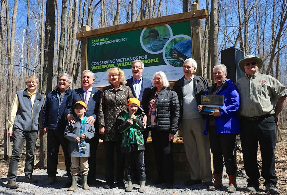 Councillor David Chernushenko, Mark Gloutney (DUC), Councillor El-Chantiry, MP Karen McCrimmon, Mayor Jim Watson, Councillor Marianne Wilkinson, representatives of the Honeywell family (Bill Honeywell, Bette Gordon, and Brady Hand), and two young Carp residents showing off their new DUC caps. Photo courtesy of Janet Mason / Friends of the Carp Hills.