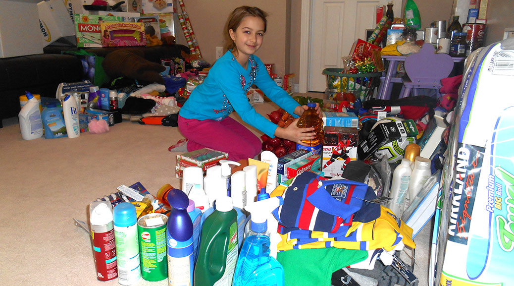 Stittsville Public School student Ella S. helps sort some of the many donations received.