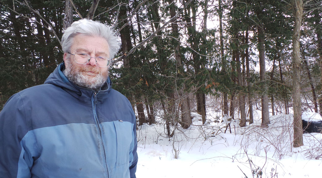 Gerry Kroll stands in front of a large grove of trees that are slated for removal beginning this week.