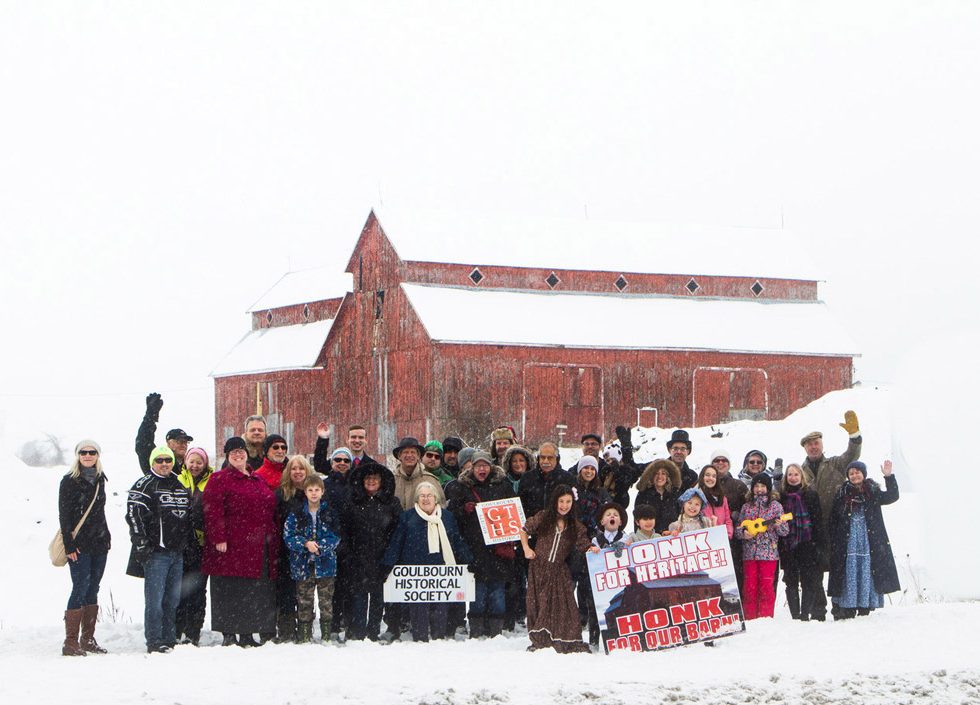 Friends of the Bradley-Craig Farm assemble for a photo in front of the landmark red barn on February 4, 2018. Photo by Rob Hambly.