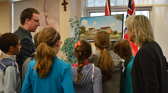Students check out an artist rendition of the new french Catholic high school in the Fernbank area. Photo supplied by the CECCE.