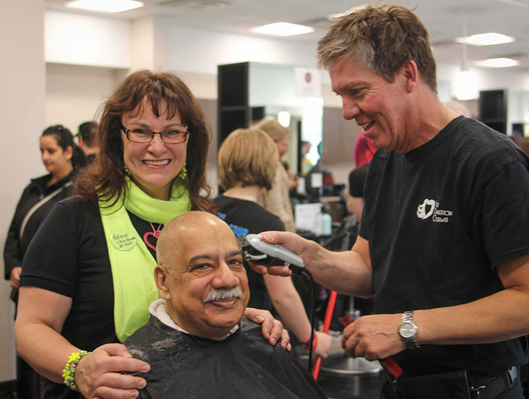 City councillor Shad Qadri had his head shaved as part of Sunday's fundraising event at Algonquin College. Wayne Patrick from Shears in Stittsville has the razor in hand. Photo by Barry Gray.