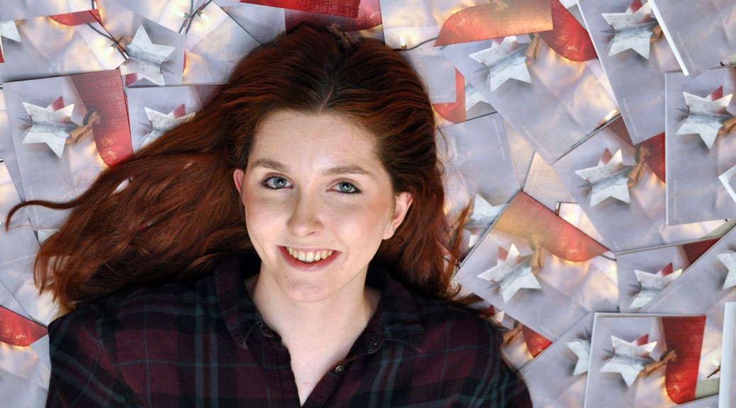 Jordyn Simpson, with the winning Christmas card design in the background