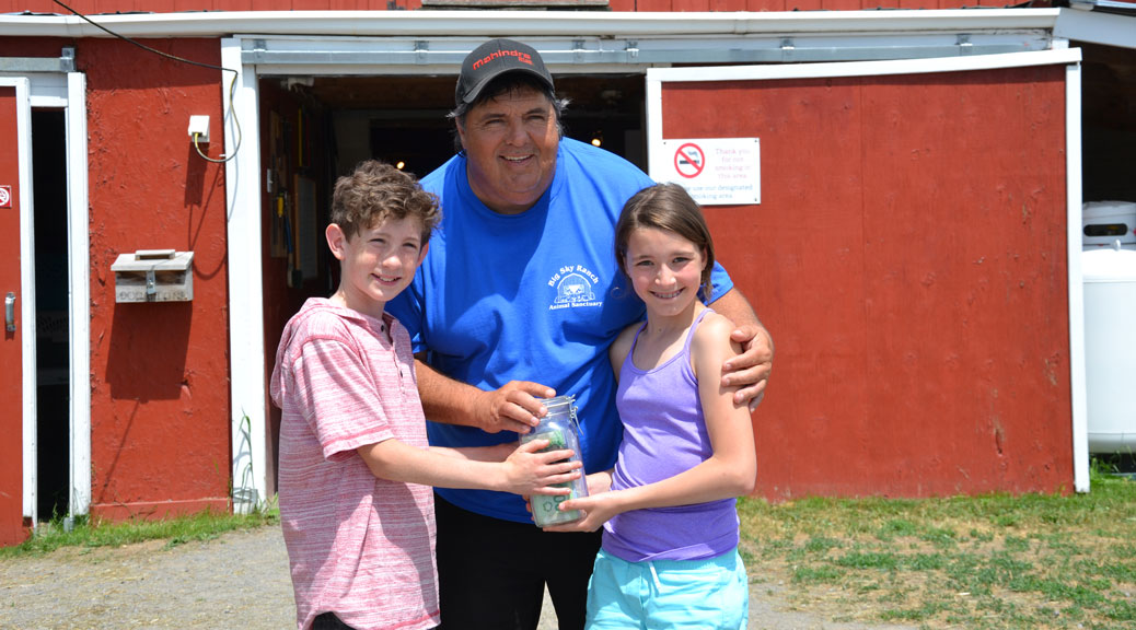 Norah and Jack present their donation to Andy Parent from Big Sky Ranch.