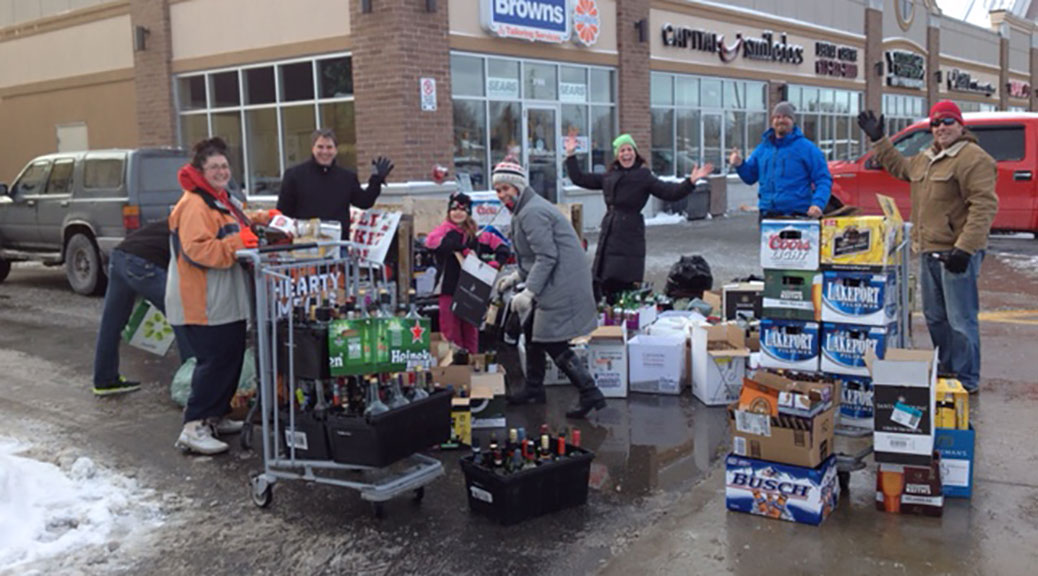 Volunteers from the Stittsville Minor Hockey Association collect bottles, raising money for the Kelly family and their son's battle with cancer.