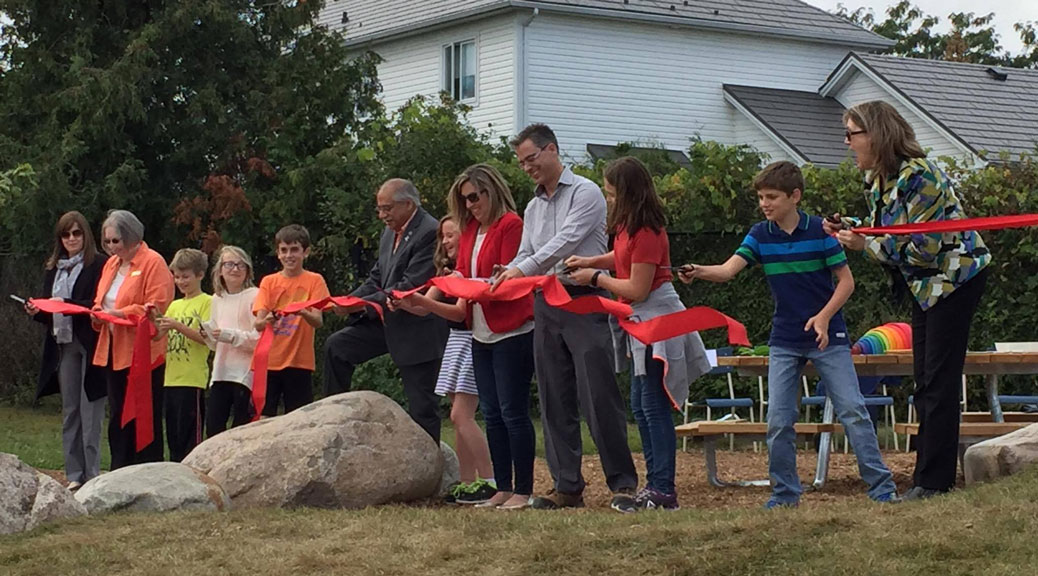 Students, staff, volunteers and elected officials took part in a ribbon-cutting ceremony -- complete with kid-sized scissors -- at Stittsville Public School on Friday, September 29. It marked the official opening of a new outdoor classrom. Photo by Lorrie Hayes.