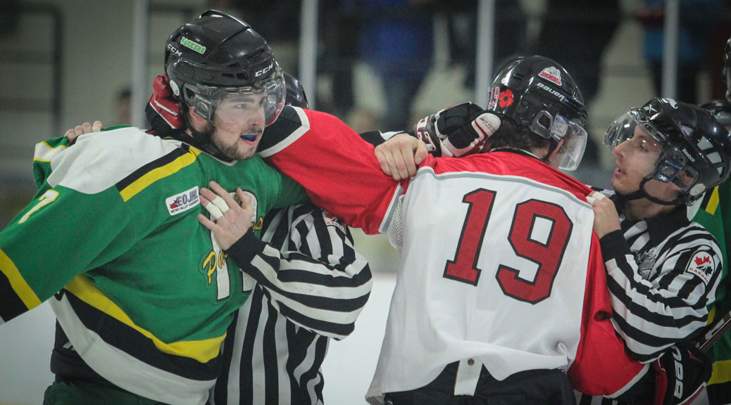 Arnprior Packers defenseman #7 Corey Drisdelle and Stittsville Junior Rams #19 Shane Hiley mix it up in the first period during Sunday afternoon Junior Hockey at Goublourn Recrecation Center. Packers went on to win the game 3-1. Photo by Barry Gray.