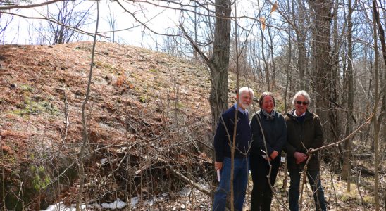 Michael MacPherson, former MMLT board instrumental in securing the land, Carolyn Canfield, and Ian Campbell, neighbour and long time friend to Carolyn. They're standing in front of the whaleback formation of glacier-sculpted Canadian Shield. Photo courtesy of Janet Mason.