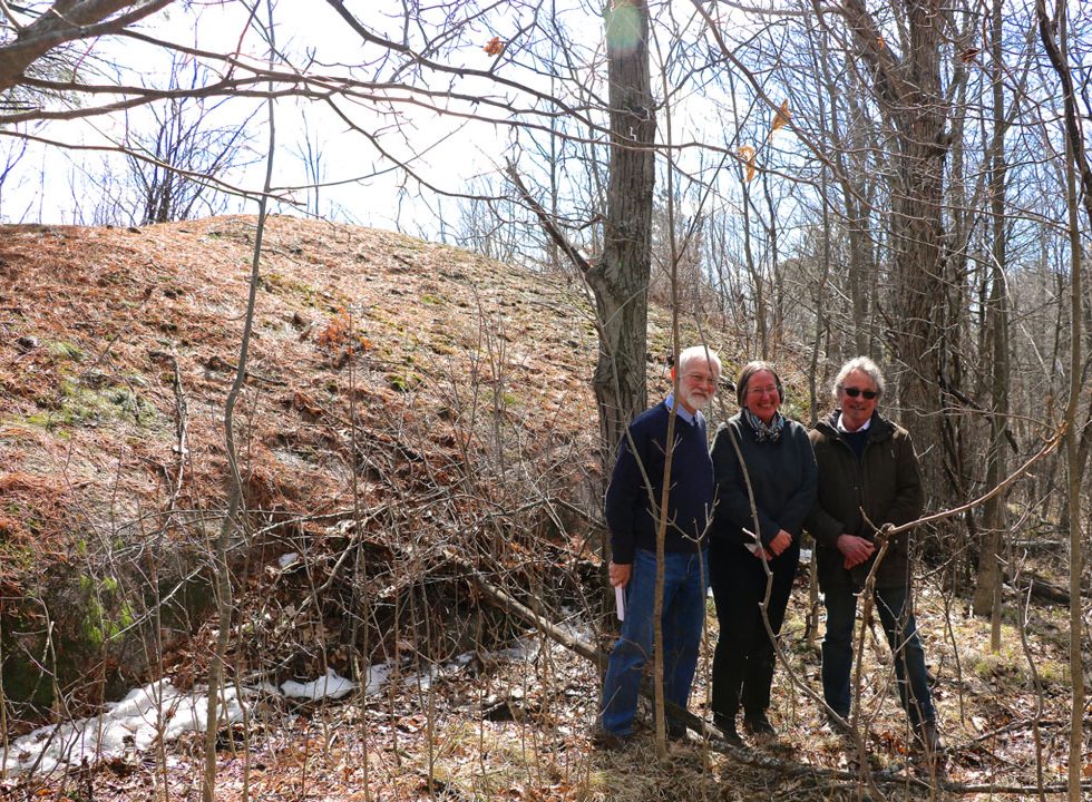 Michael MacPherson, former MMLT board instrumental in securing the land, Carolyn Canfield, and Ian Campbell, neighbour and long time friend to Carolyn. They're standing in front of the whaleback formation of glacier-sculpted Canadian Shield. Photo courtesy of Janet Mason.